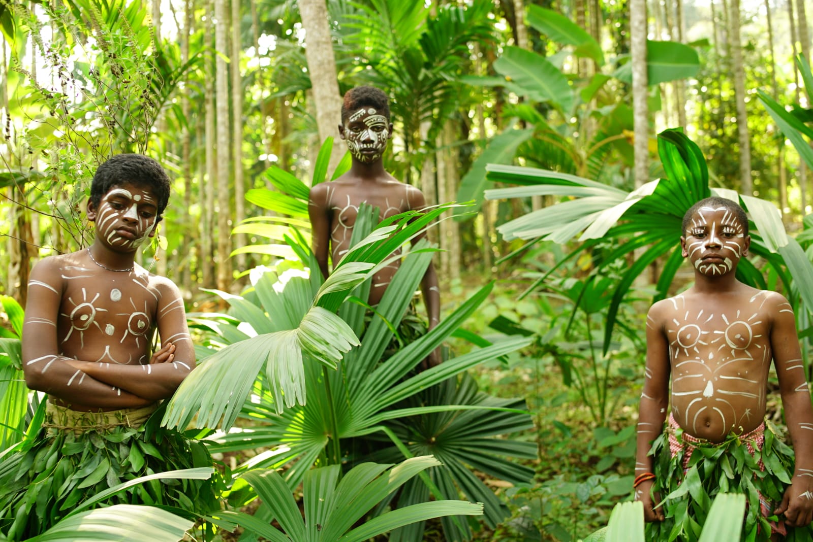 Siddi youth adorned with traditional tribal body paint and natural foliage during the Ethno Cultural Camp in the Western Ghats